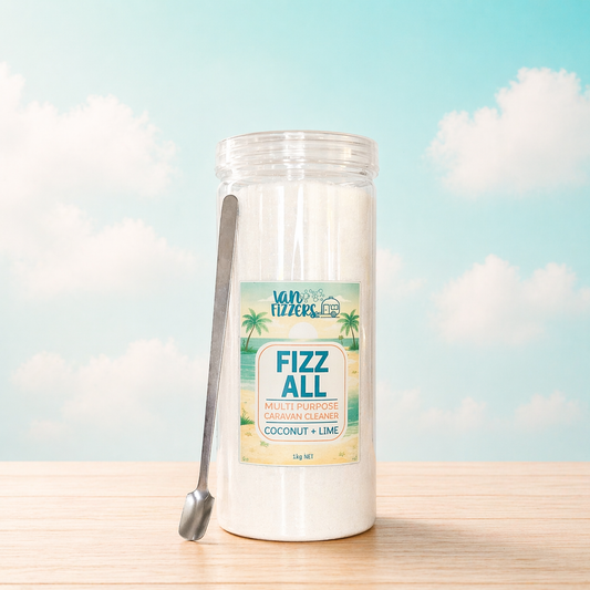 Jar of 'Fizz All' multi-purpose cleaner with a label on a wooden surface and sky background